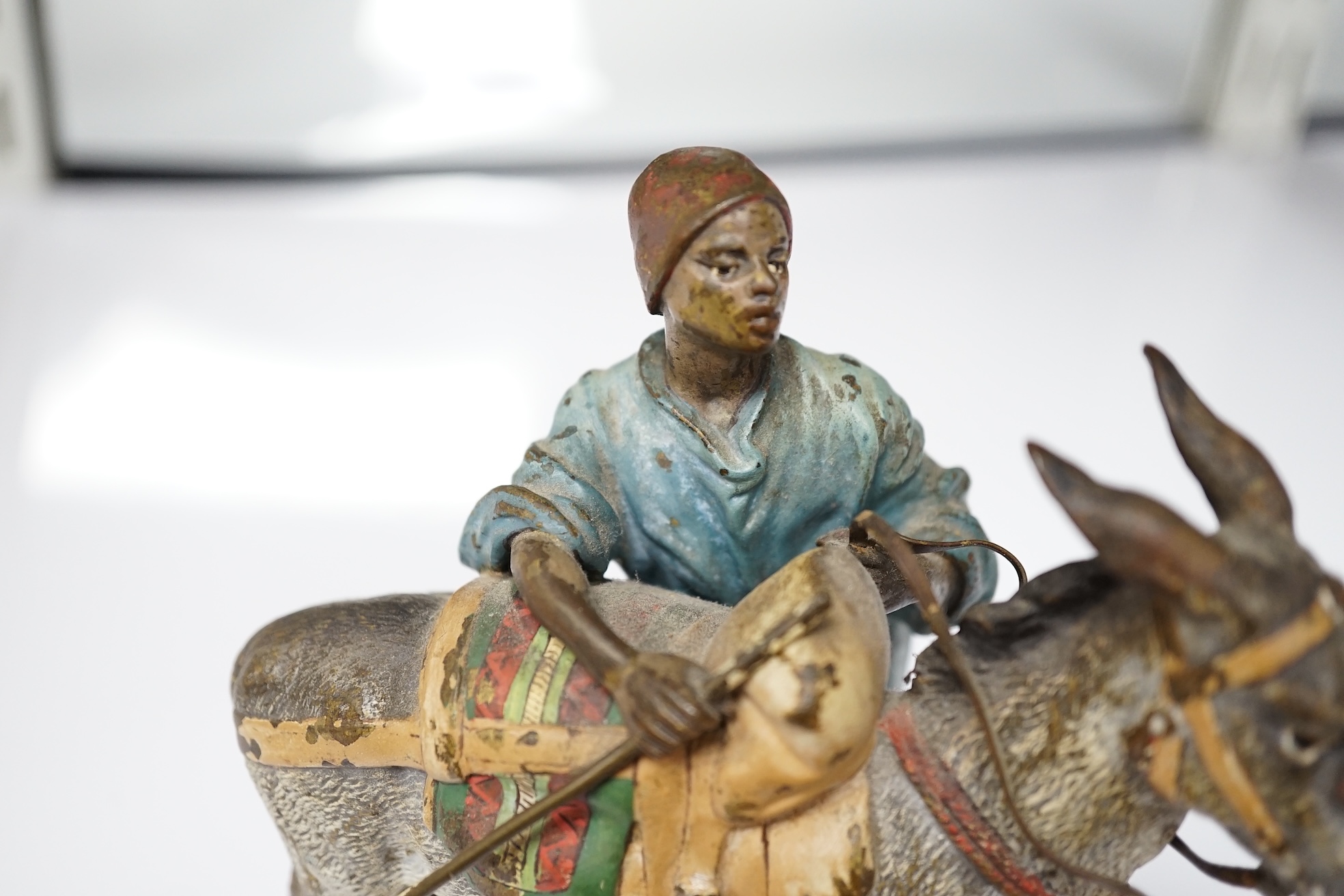 A Viennese cold painted bronze of an Arab trader with mule, 14cm high, 13cm wide. Condition - slight chipping to painted areas